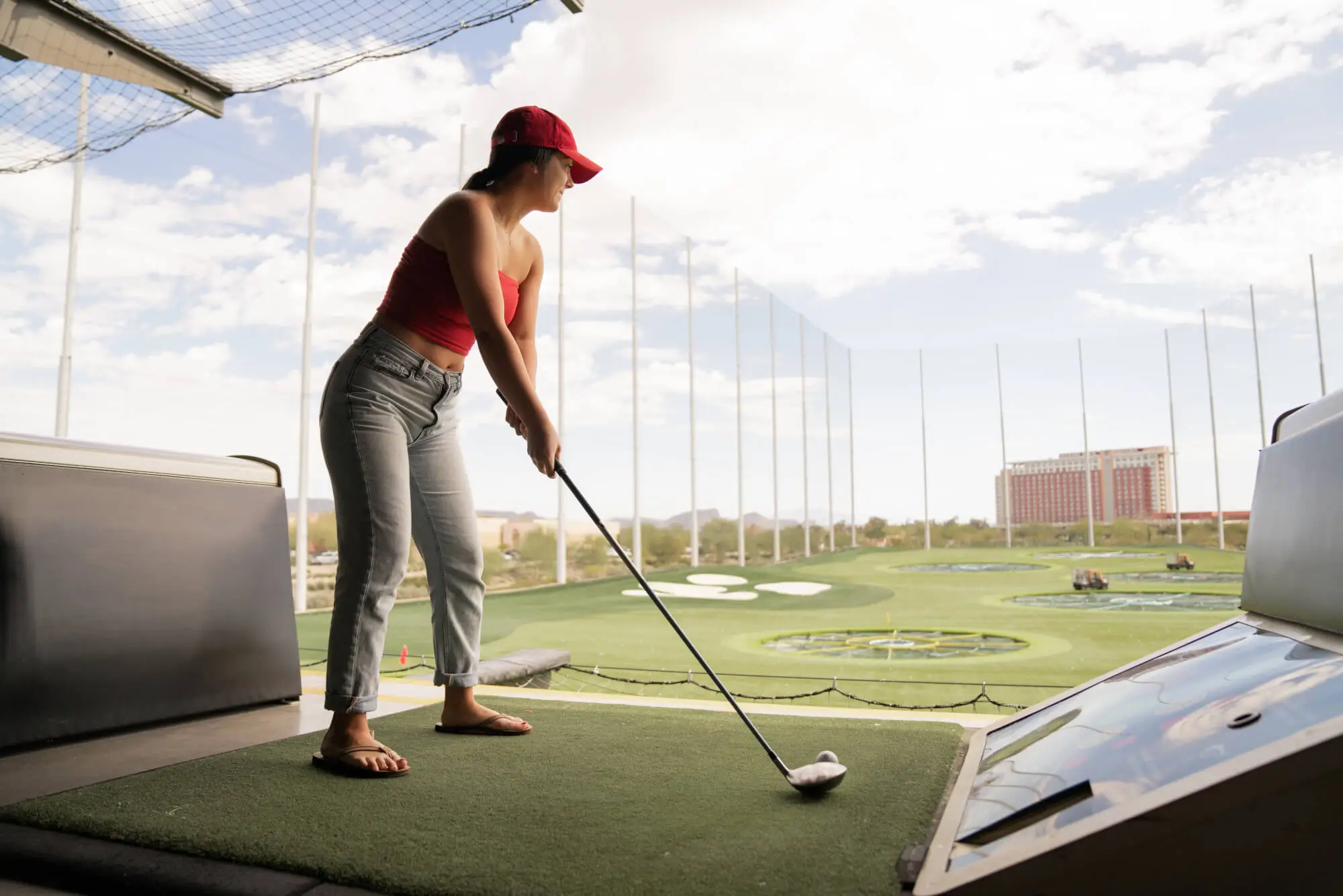 Girl playing golf at Top Golf